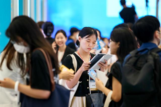 A visitor reviews a resume at the Finance Job Fair 2024 held at Dongdaemun Design Plaza in Seoul on Aug 21 2024 AJU PRESS Kim Dong-woo