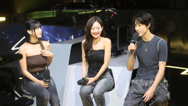 Kiss of Lifes members Natty left and Julie center and GOT7’s member Mark right the artists behind the 2024 Valorant Champions Seoul theme song give an interview at the media day preceding the finals series at LoL Park in Seoul on Aug 21 AJU PRESS Han Jun-gu