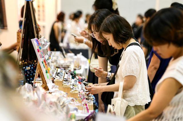 Visitors view handmade products at the Hand Arti Korea exhibition at COEX in Seoul on Aug 22 2024 AJU PRESS Kim Dong-woo