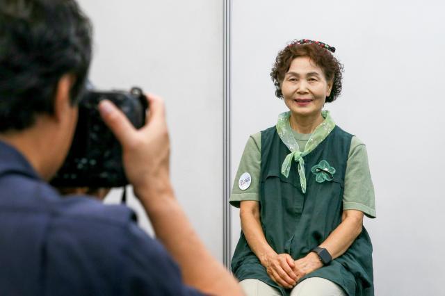 A woman poses for a resume photo at a job fair for middle-aged and elderly people at Dongdaemun Design Plaza in Seoul AJUPRESS Kim Dong-woo
