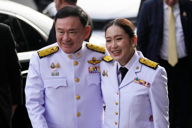 Former PM Thaksin Shinawatra and his daughter newly elected PM Paetongtarn Shinawatra arrive at Pheu Thai party headquarters in Bangkok for her royal endorsement ceremony on August 18 2024 Yonhap