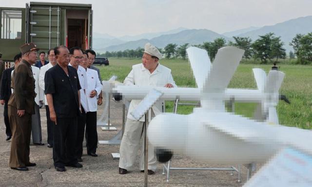 This photo carried by North Koreas official Korean Central News Agency on Aug 26 2024 shows the 

North Korean leader Kim Jong-un far right inspects a test of drones at an undisclosed location in North Korea on Aug 24 in this photo released by Pyongyangs Korea Central News Agency on Aug 26 2024