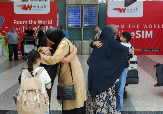 People hug each other at the Beirut-Rafic Hariri International Airport in Beirut Lebanon Aug 26 2024 Reuters-Yonhap