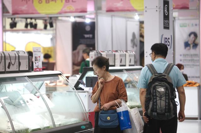 A visitor examines products closely at the 2024 Festive Gift Fair at COEX in Seoul on Aug 26 2024 AJU PRESS Han Jun-gu