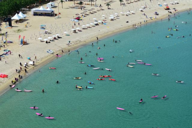 Surfers try to catch waves at a beach in Yangyang in Gangwon Province on July 29  Yonhap Photo