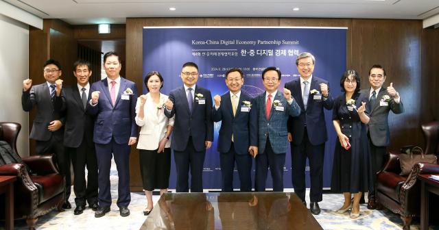 Yang Gyu-hyeon Aju Daily president fifth from right and Fang Ku Acting Ambassador of the Chinese Embassy to South Korea fifth from left pose for a photo with participants at the Korea-China Digital Economy Partnership Summit in Jung-gu Seoul on Aug 28 2024 AJP Kim Dong-woo