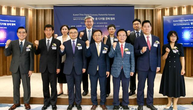 Yang Gyu-hyeon Aju Daily president fourth from left front row and Fang Ku third from left front row Acting Ambassador of the Chinese Embassy to South Korea fifth from left pose for a photo with participants at the Korea-China Digital Economy Partnership Summit in Jung-gu Seoul on Aug 28 2024 AJP Kim Dong-woo