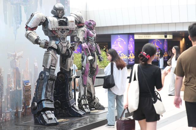 A visitor observes the Transformers One character statues installed at COEX Millennium Plaza Seoul on August 26 2024 AJP Han Jun-gu