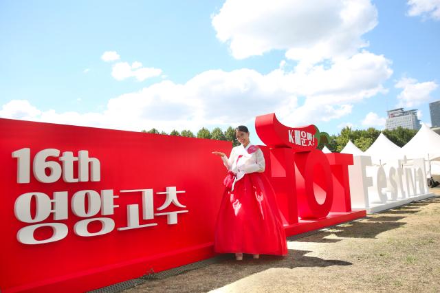 A promotional ambassador poses for a photo in front of the HOT Festival sculpture at the HOT Festival held in Seoul Plaza August 29 2024 AJP Han Jun-gu