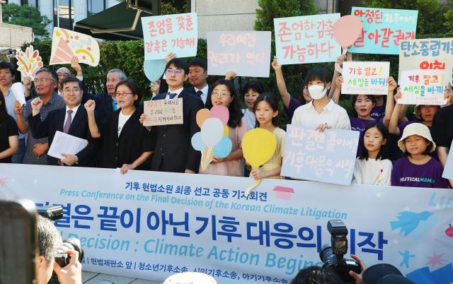 Civic activists and Han Je-ah are raising their voices for new climate change targets at a press conference in front of the Constitutional Court in Jongno-gu Seoul on August 29 2024