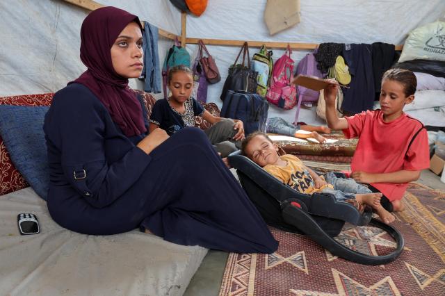 A Palestinian boy the first person to contract polio in Gaza in 25 years lies beside his sisters in the Gaza Strip on Aug 28 2024