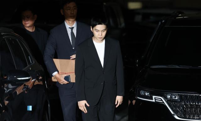 Suga a member of K-pop boy band BTS center arrives for an investigation at a police station in Yongsan Seoul on Aug 23 2024 Yonhap Photo