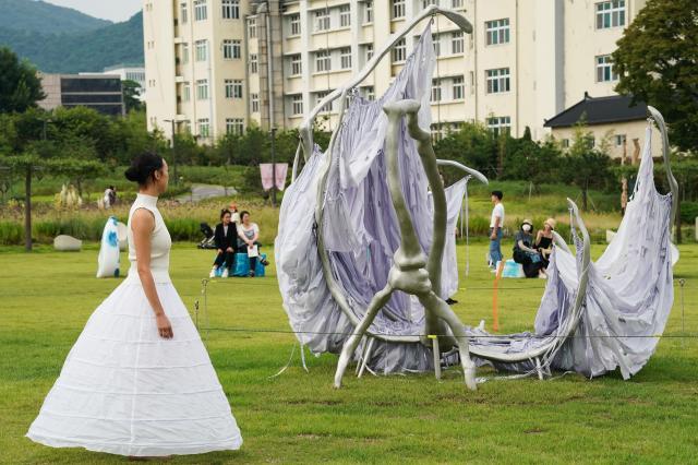 A dancer performs contemporary dance among sculpture installations at the Seoul Sculpture Festival in Songhyeon Green Plaza Jongno District Seoul Monday Sept 2 2024 AJP Park Jong-hyeok