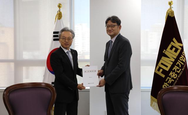 This photo shows the chair of the Federation of Middle Market Enterprises of Korea FOMEK Choi Jin-shik left meeting Kwon Gi-seob chairman of the Economic Social  Labor Council ESLC on Sept 3 2024 Courtesy of the Federation of Middle Market Enterprises of Korea FOMEK