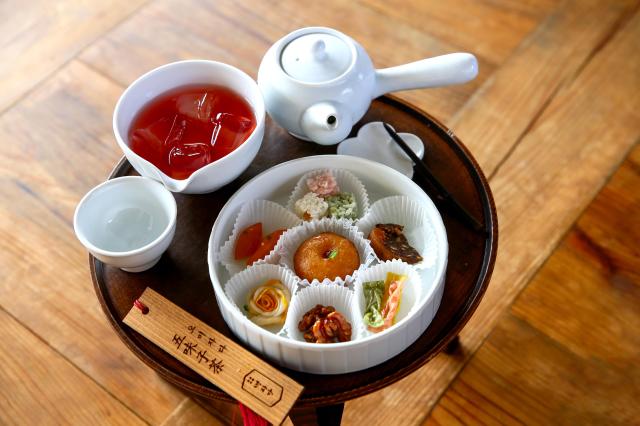 The image shows seven Korean traditional snacks and 
schisandra tea being served at Gyeongbokgung Palace central Seoulon Sep 3 2024 AJP Kim Dong-woo