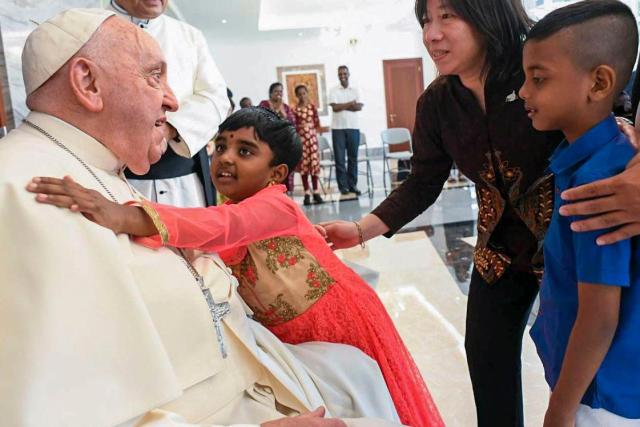 This photo shows Pope Francis greeted by children as he arrives in Jakarta Tuesday Sept 3 2024 Yonhap