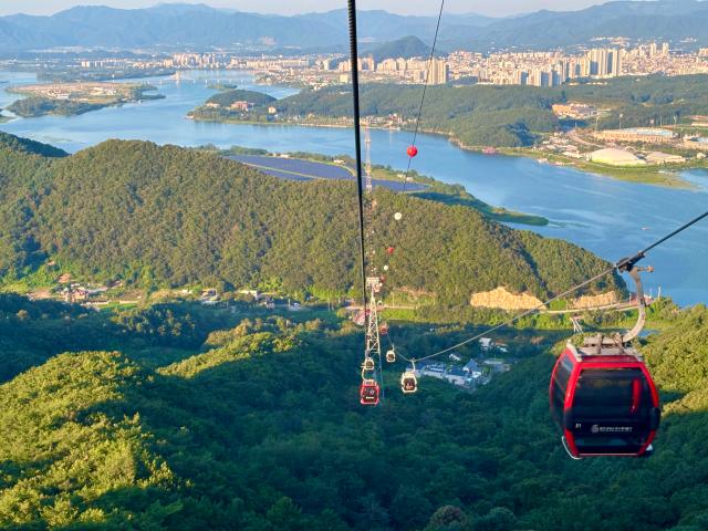 A cable car passes above Mt Samak in the eastern city of Chuncheon Aug 31 2024 AJP Han Jun-gu