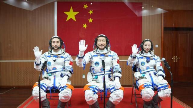 Chinese astronauts  Wang Yaping right Zhai Zhigang center and Ye Guangfu left wave to the camera at the Jiuquan Satellite Launch Center in northwest China on October 15 2021Xinhua-Yonhap