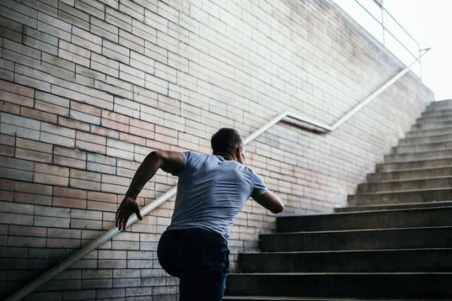 This photo shows a man running up the stairs Getty Images Bank