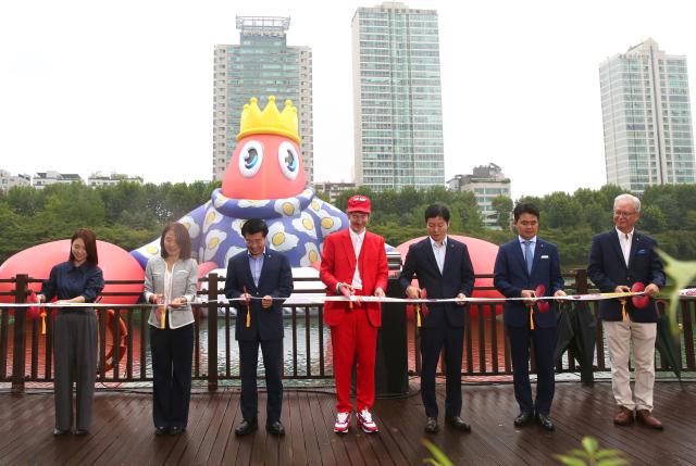 Philip Colbertcenter performs a ribbon-cutting ceremony at the opening of the public art project Lobster Wonderland at Seokchon Lake Sept 6 2024 AJP Han Jun-gu