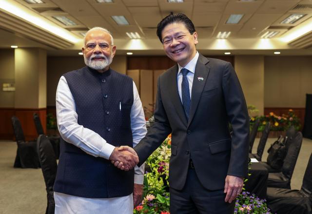 Indian Prime Minister Narendra Modi and Singapores Prime Minister Lawrence Wong exchange a handshake at Singapores Parliament House during their official meeting on September 5 2024 AFP-Yonhap