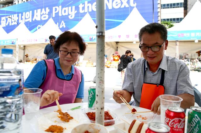 A visitor eats food at the K-Shopping Festa at Cheonggye Plaza in Seoul on Sept 9 2024 AJP Kim Dong-woo