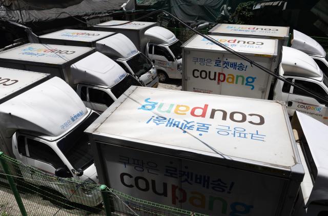 This photo shows Korean e-commerce giants delivery vehicles parked in downtown Seoul June 13 2024 Yonhap