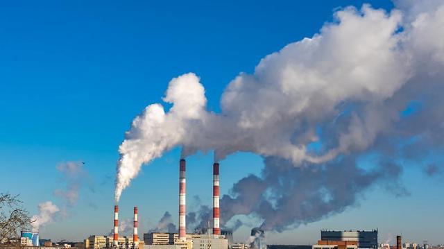 This photo shows smoke coming out of a factory Getty Images Bank