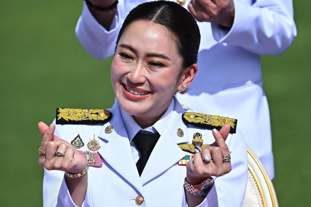 Thailands new Prime Minister Paetongtarn Shinawatra gestures a Korean heart during a group photo with members of the cabinet at Government House in Bangkok on September 7 2024 AFP-Yonhap