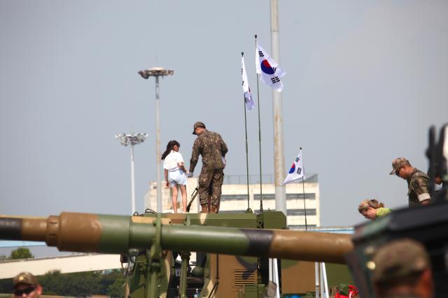 A child stands on a tank with a soldier at the 74th anniversary commemoration of the Incheon Landing Operation in Incheon Sep 11 2024 AJP Han Jun-gu