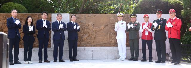 Officials unveil a new relief sculpture during the ceremony at General MacArthurs statue in Incheon Sep 11 2024 AJP Han Jun-gu