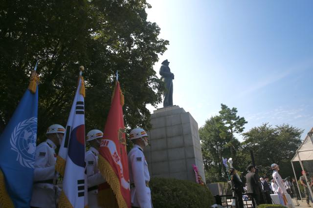 Soldiers hold the UN flagleft flag of the Republic of Korea and Marine Corps flag during the ceremony at General MacArthurs statue in Incheon Sep 11 2024 AJP Han Jun-gu