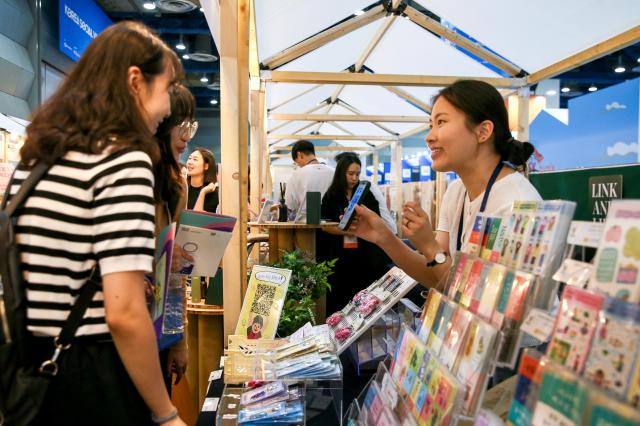 Visitors listen to a booth representative during the Korea Social Value Festa at COEX in Seoul on Sept 12 2024 AJP Kim Dong-woo