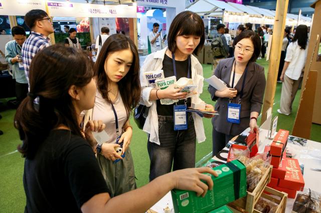 Visitors listen to a booth representative during the Korea Social Value Festa at COEX in Seoul on Sept 12 2024 AJP Kim Dong-woo