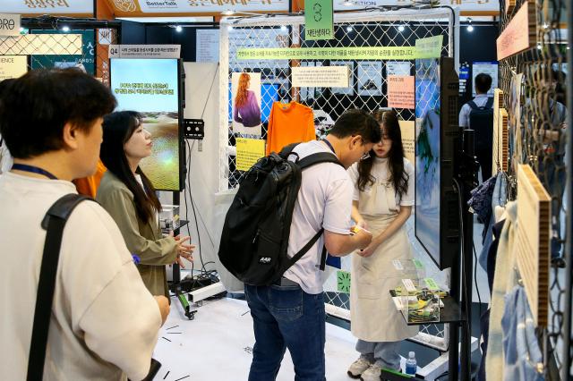 A visitor participates in a booth event during the Korea Social Value Festa at COEX in Seoul on Sept 12 2024 AJP Kim Dong-woo