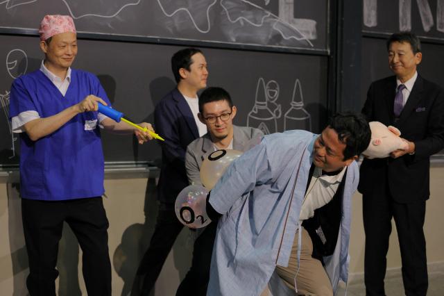 This photo shows a team of Japanese and American scientists demonstrating their research of anal breathing at the Ig Nobel physiology prizes Sept 12 2024 Reuters - Yonhap