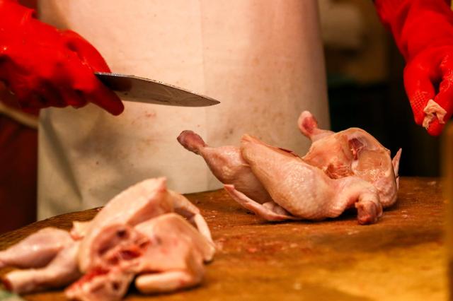 A vendor prepares fresh chicken at a shop in Kyungdong Market Dongdaemun-gu Seoul on Sept 13 2024 AJP Kim Dong-woo