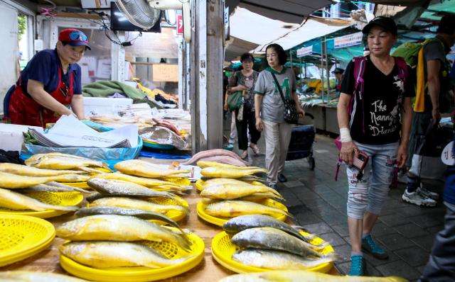 Visitors walk past shops at Kyungdong Market in Dongdaemun-gu Seoul on Sept 13 2024 AJP Kim Dong-woo