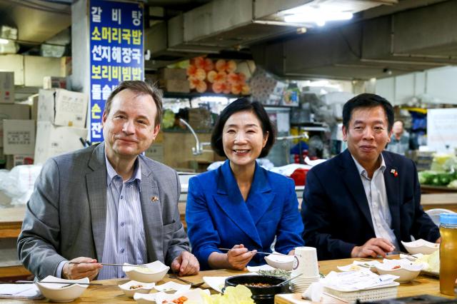 Minister Oh Young-ju center of SMEs and Startups poses with German Ambassador Georg Wilfried Schmidt left and Vietnamese Ambassador Vu Ho at Kyungdong Market in Dongdaemun-gu Seoul on Sept 13 2024