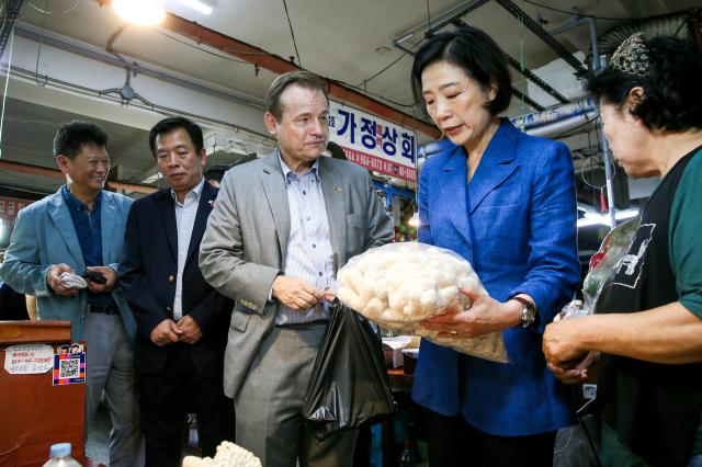 Minister and ambassadors examine goods at a shop in Kyungdong Market Dongdaemun-gu Seoul on Sept 13 2024 AJP Kim Dong-woo