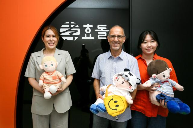 Hyodol CEO Kim Jee-hee left J Artur Serrano center a professor at NTNUs Department of Neuromedicine and Movement Science and KAIST researcher Shin Hee-sun right pose for a photograph at the office of Hyodol a Korean carerobot company located in Anyang south of Seoul on Sept 11 SJP Kim Dong-woo