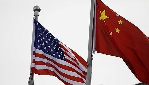 The image shows national flags of the United States left and China right Reuters-Yonhap