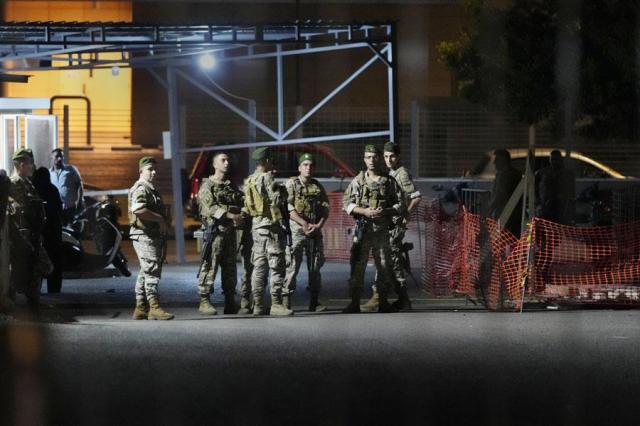 Lebanese soldiers stand guard as their comrades prepare to detonate a walkie-talkie that was found at the parking of the American University Hospital in Beirut Lebanon on Sept 18 2024 AP-Yonhap 