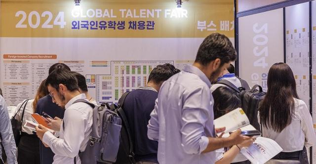 Foreign students attending the 2024 Global Talent Fair Job Fair look through job postings in search of employment opportunities in Korea in central Seoul on August 27 2024 Yonhap