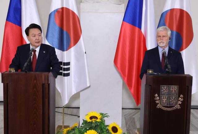 President Yoon Suk Yeol right speaks during a joint press conference with Czech President Petr Pavel left at Prague Castle in the Czech Republic on Sept 19 local time Yonhap