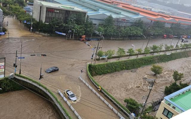 Cars are stranded on a flooded road in Busan on Sept 21 2024 Yonhap