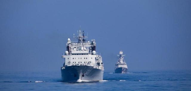 Supply ship Hoh Xil foreground and the missile frigate Rizhao background of the Chinese Peoples Liberation Army Navys 42nd fleet sails at sea near Chinas port city of Qingdao in Shandong Province on February 8 2023 Xinhua-Yonhap