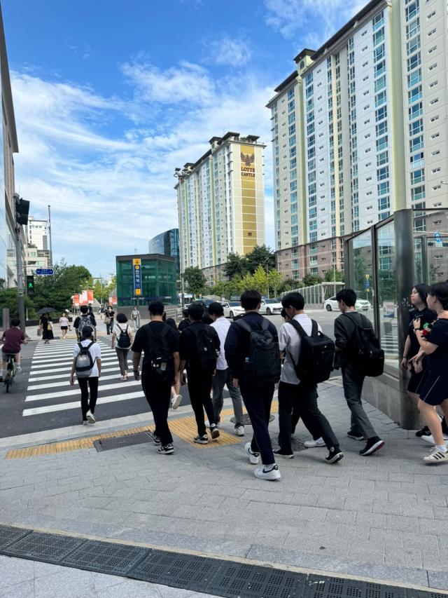 Students returning from school cross the street in Daechi-dong Seoul Korea