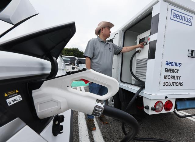 An electric car is charged near Seoul on Sept 13 2024 Yonhap