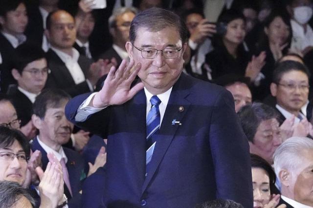 Shigeru Ishiba center waves as he is elected as leader of the ruling Liberal Democratic Party after the partys leadership election in Tokyo on Sept 27 2024 AP-Yonhap